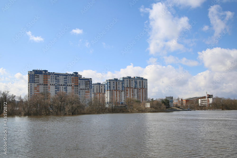 Residential complex by the river in the spring. Residential complex by the river in the spring.