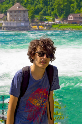 Happy young man insunglasses in rhine falls, Switzerland	
