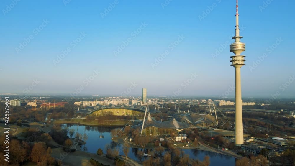 Drone flies over the Olympiapark Munich during sunrise in the morning ...
