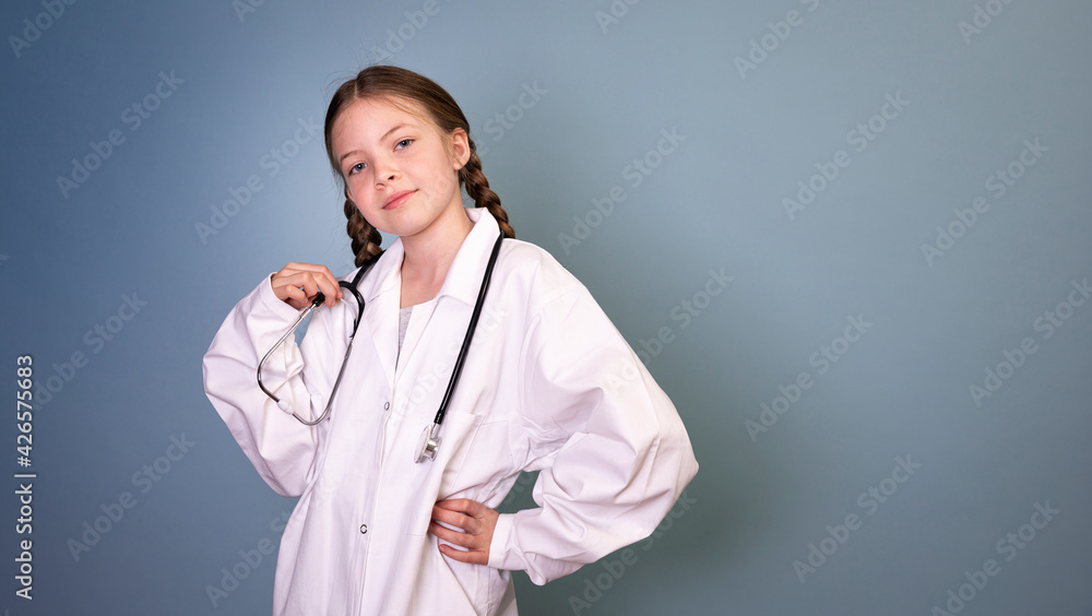 pretty girl with two braids is dressed as doctor and posing with stethoscope on blue background, concept professions, future, job choice, training pretty girl with two braids is dressed as doctor and posing with stethoscope on blue background, concept professions, future, job choice, training