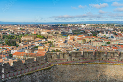 Aerial view of the city of Carcassonne with the church from the castle of Carccasonne, background blue sky