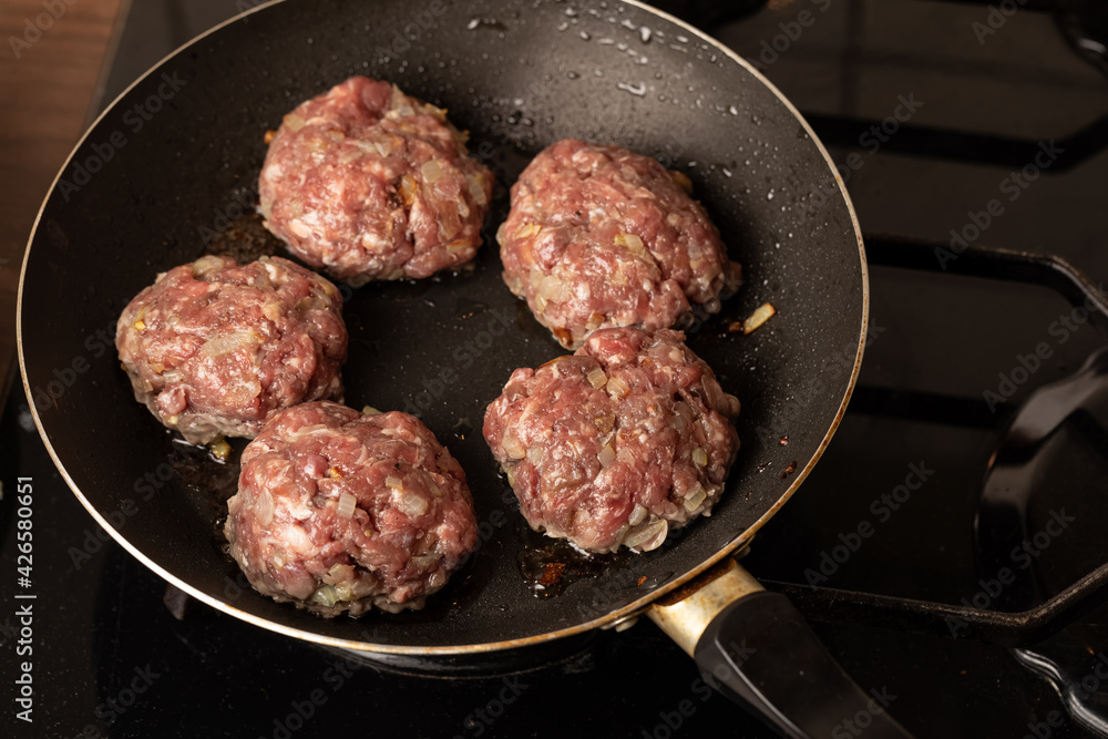 The process of cooking and roasting beef meat cutlets in a frying pan The process of cooking and roasting beef meat cutlets in a frying pan