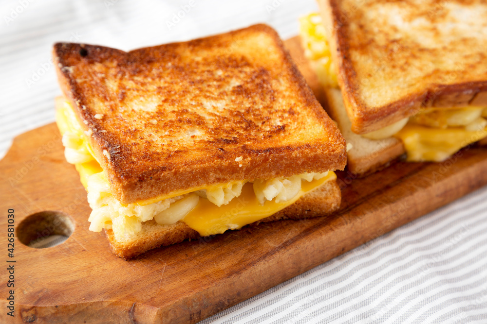 Homemade Grilled Macaroni and Cheese Sandwich on a rustic wooden board, side view. Close-up. Homemade Grilled Macaroni and Cheese Sandwich on a rustic wooden board, side view. Close-up.