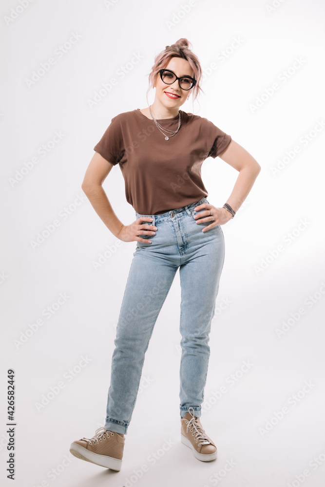 Hipster girl in glasses and jeans on a white background Hipster girl in glasses and jeans on a white background