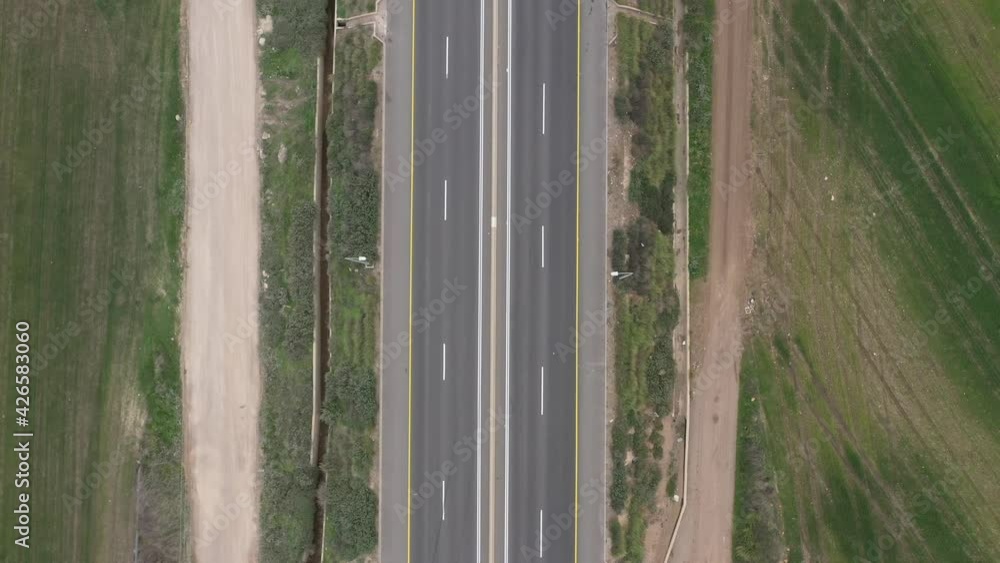 Traffic on a Countryside Highway road surrounded by Agricultural fields, Aerial view.
Traffic on a Countryside Highway road surrounded by Agricultural fields, Aerial view.