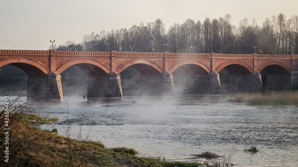 Long brick bridge and fishermans, Kuldiga, Latvia. Long brick bridge and fishermans, Kuldiga, Latvia.