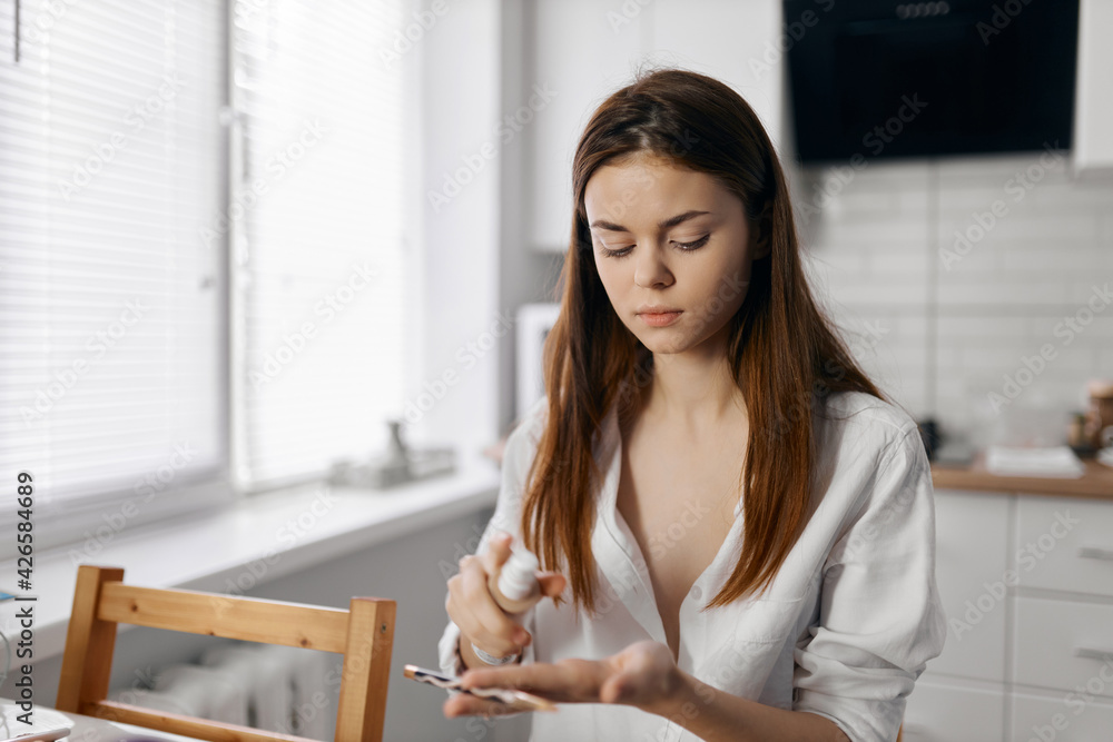 woman at table with makeup brush eyeliner model woman at table with makeup brush eyeliner model