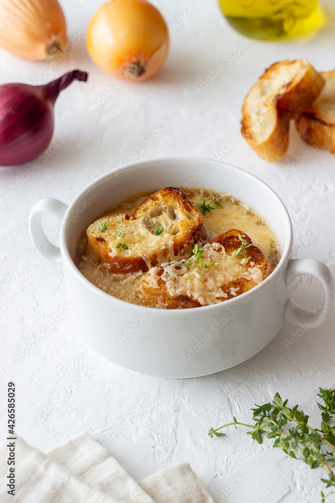 French onion soup with toasts and cheese. French cuisine. Vegetarian food. French onion soup with toasts and cheese. French cuisine. Vegetarian food.