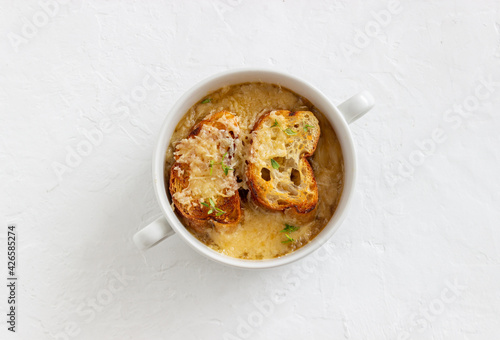 French onion soup with toasts and cheese. French cuisine. Vegetarian food.