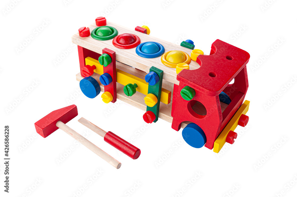 Naklejka premium Truck made of wood on a rope. Constructor game and hammer with a hammer for children. Educational toy Montessori 3 in 1 White background. Close-up.