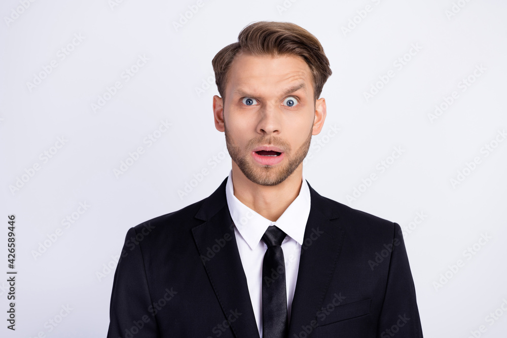 Photo of young man unhappy amazed shocked surprised news stupor reaction isolated over grey color background Photo of young man unhappy amazed shocked surprised news stupor reaction isolated over grey color background