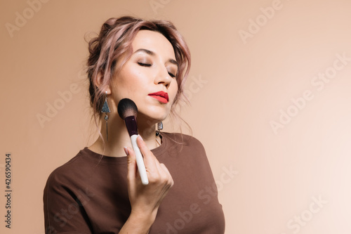 Girl with glasses demonstrates cosmetics