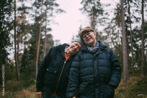 Wallpaper Mural Portrait of smiling gay couple standing in forest Torontodigital.ca
