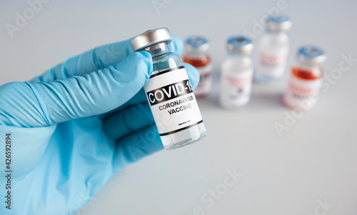 The nurse holding one form five types of covid 19 vaccines in hand