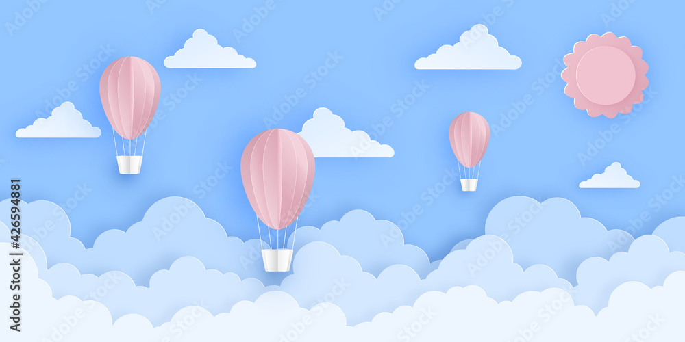 Pink beautiful hot air balloons flying over fluffy clouds in the sky with sun.