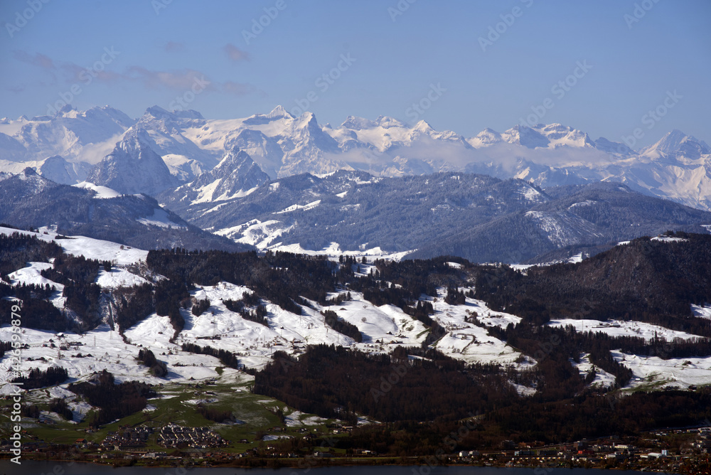 Panoramic landscape with snow capped Swiss alps in the background. Photo taken April 8th, 2021, Zurich, Switzerland.