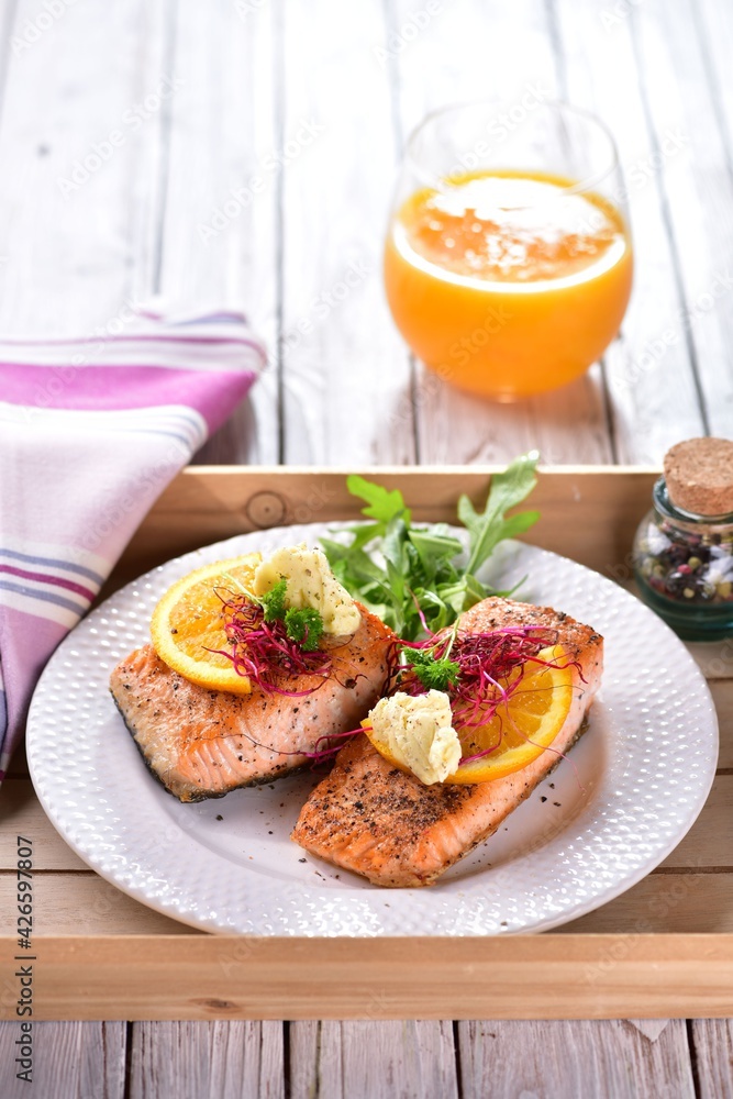 Grilled salmon fish with orange butter and rocket salad Grilled salmon fish with orange butter and rocket salad