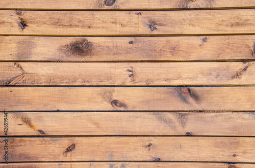 Close-up wooden surface. Old fence made of wooden beams. Grunge wooden texture with horizontal planks. Wood texture with copy space.