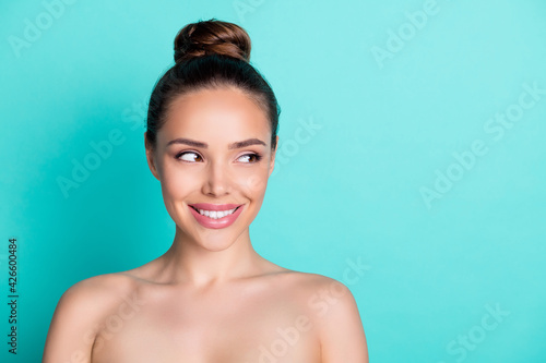 Photo of young happy dreamy smiling woman wear no clothes look copyspace isolated on teal color background