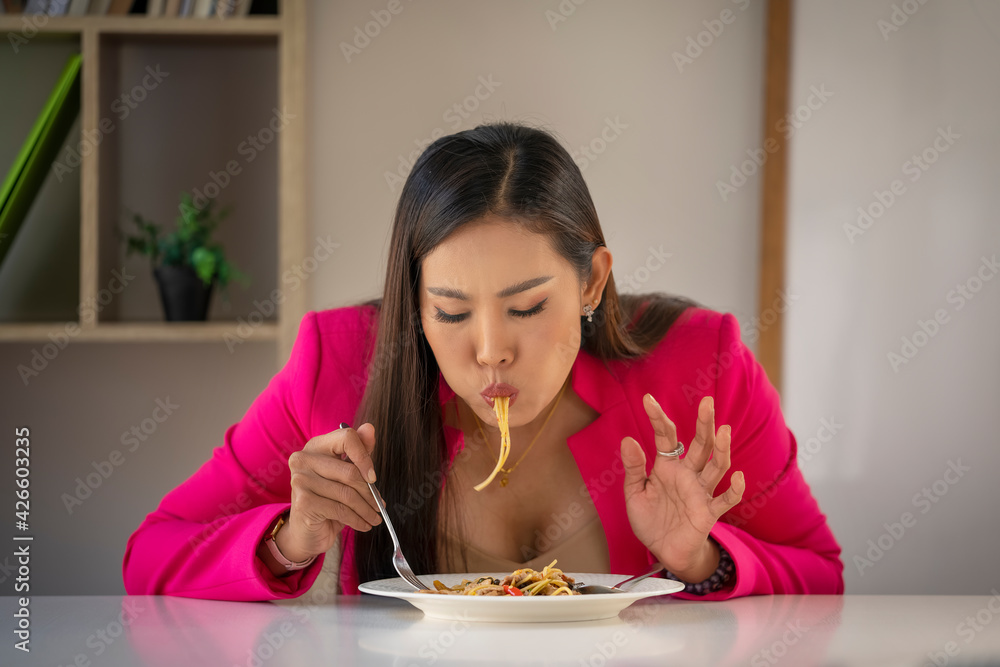 Hungry people eating spaghetti. A plate of pasta and a fork wildly eats pasta. Hungry people eating spaghetti. A plate of pasta and a fork wildly eats pasta.