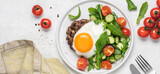 Chopped beef steak with fried egg and salad. Delicacy dinner in  plate on white background. Healthy food concept