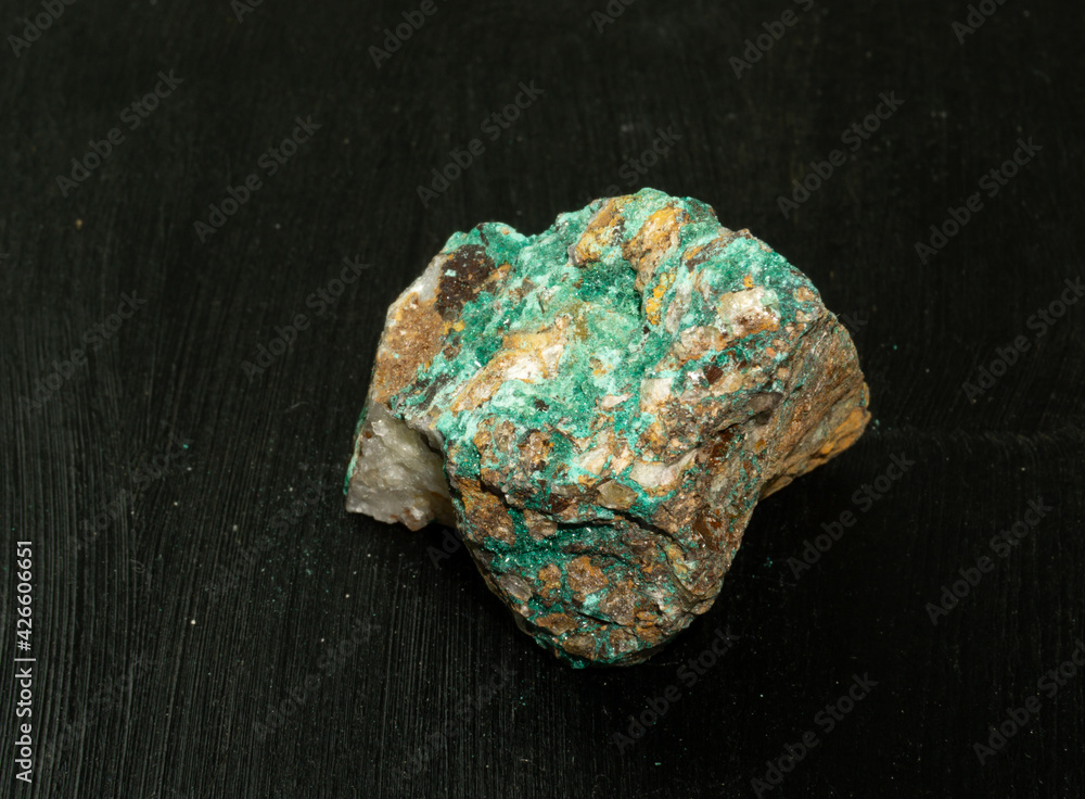 Malachite from Morocco or Republic of the Congo. Natural mineral stone on black background. Mineralogy, geology, magic of stones, semi-precious stones and samples of minerals. Close-up macro photo. Malachite from Morocco or Republic of the Congo. Natural mineral stone on black background. Mineralogy, geology, magic of stones, semi-precious stones and samples of minerals. Close-up macro photo.