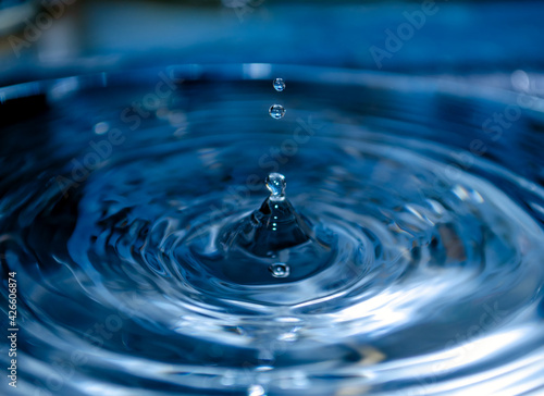 A crystal drop of water falls on the surface of the water surface