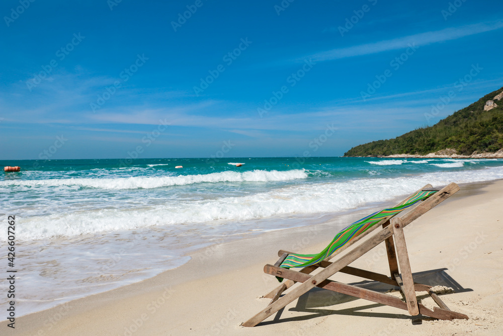 Green Deck chair at the tropical sandy beach with blue wave and clear sky in summer time Green Deck chair at the tropical sandy beach with blue wave and clear sky in summer time