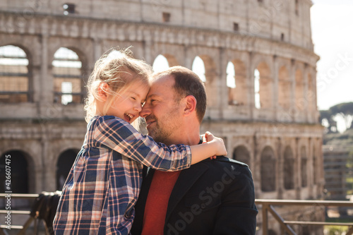 dad and daughter hug near the Colosseum in Rome, Italy