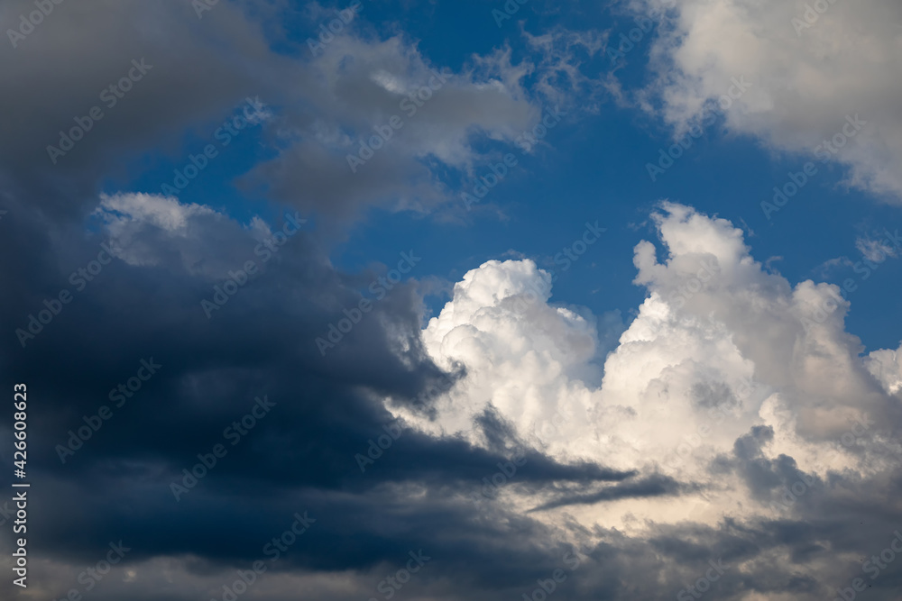 Fototapeta premium Stormy skies, dark and light clouds. Concept of changing the weather