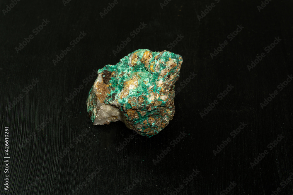 Malachite from Morocco or Republic of the Congo. Natural mineral stone on black background. Mineralogy, geology, magic of stones, semi-precious stones and samples of minerals. Close-up macro photo. Malachite from Morocco or Republic of the Congo. Natural mineral stone on black background. Mineralogy, geology, magic of stones, semi-precious stones and samples of minerals. Close-up macro photo.