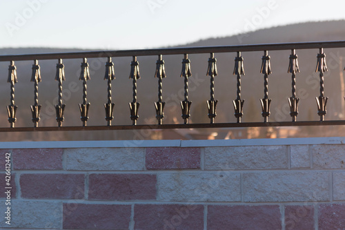 metal fence on a stone wall photo