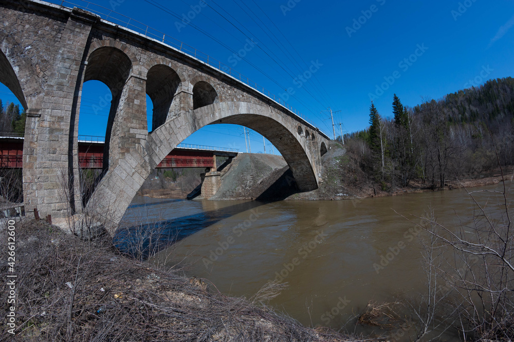 Fototapeta premium arched old bridge over the river