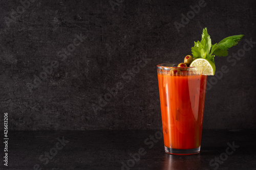 Tableau sur toile Bloody Mary cocktail in glass on black background. Copy space