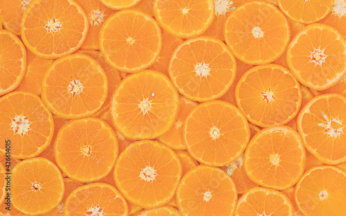 Natural background of sliced round tangerines - top view 
