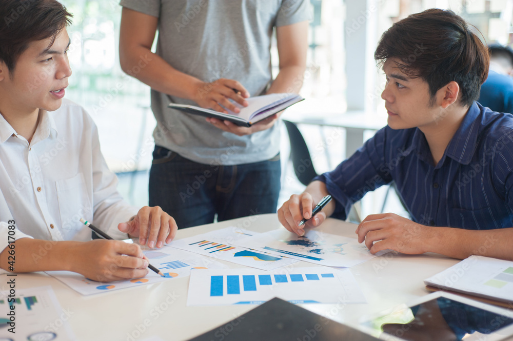 The concept of human relations with colleagues and interviews. The young man smiled and happily worked with his colleagues. The concept of human relations with colleagues and interviews. The young man smiled and happily worked with his colleagues.