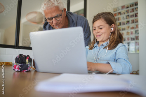 father with daughter home schooling