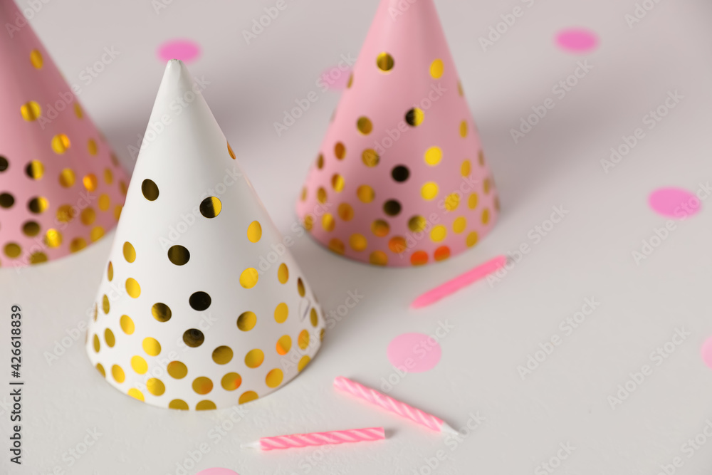 Birthday party hats and candles on light table Birthday party hats and candles on light table