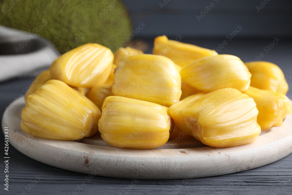 Fresh exotic jackfruit bulbs on grey wooden table, closeup Fresh exotic jackfruit bulbs on grey wooden table, closeup