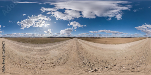 Full spherical seamless hdri panorama 360 degrees angle view on no traffic white sand gravel road among fields with cloudy sky in equirectangular projection  VR AR content