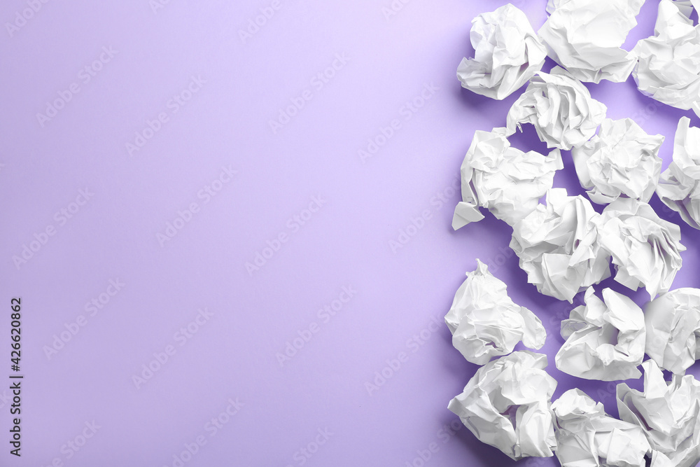 Crumpled sheets of paper on lilac background, flat lay. Space for text Crumpled sheets of paper on lilac background, flat lay. Space for text