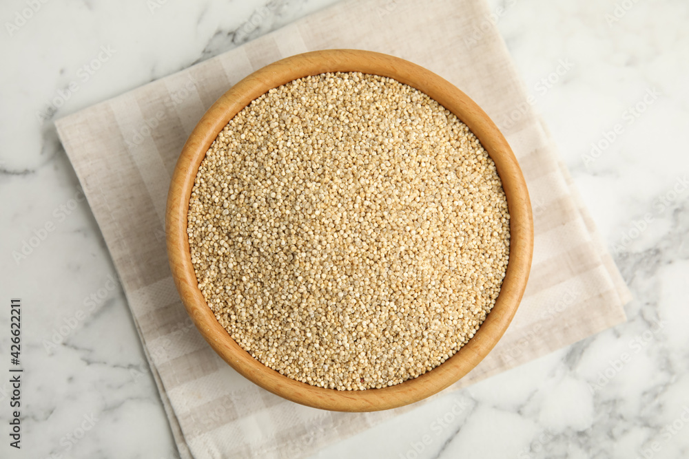 Bowl with white quinoa on marble table, top view Bowl with white quinoa on marble table, top view