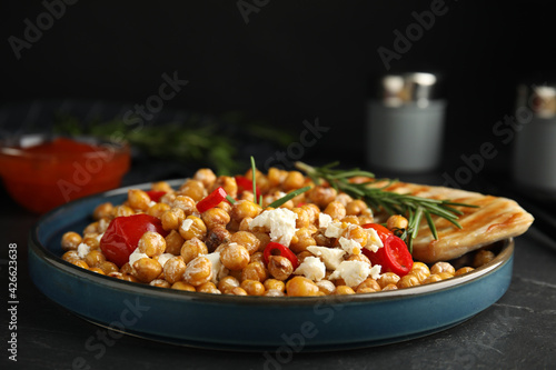 Delicious fresh chickpea salad on black table