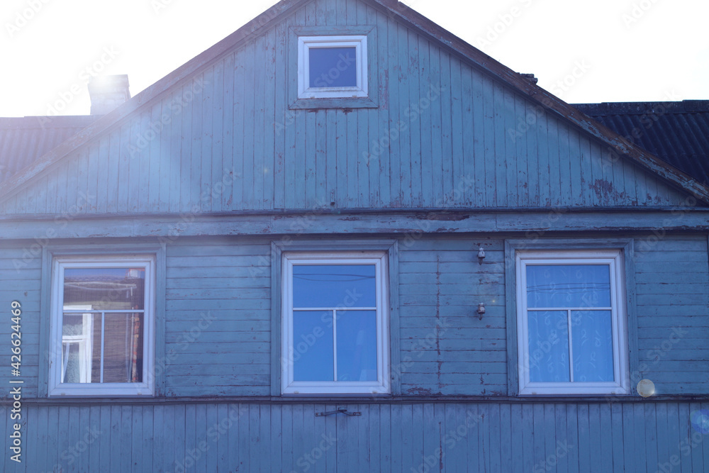 old blue wooden house with white windows old blue wooden house with white windows