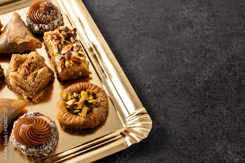 Assortment of Ramadan dessert baklava on black background. Copy space photo