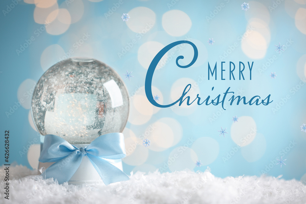 Merry Christmas. Beautiful snow globe against against blurred festive lights Merry Christmas. Beautiful snow globe against against blurred festive lights
