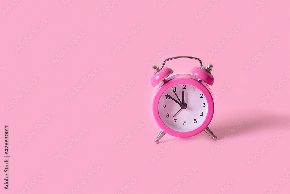 Pastel pink clock on pink painted wall. Minimal time concept. Chrismas eve or new year idea. Pastel pink clock on pink painted wall. Minimal time concept. Chrismas eve or new year idea.