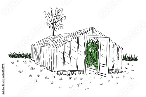 Greenhouse on the grass with tree and bushes