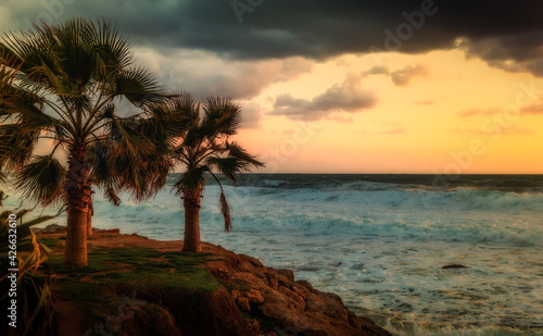 Cloudy sunset in the stormy sea on a tropical island.