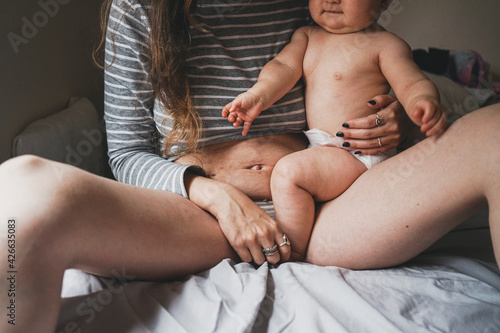 Real image of a woman and her baby at postpartum recovery photo